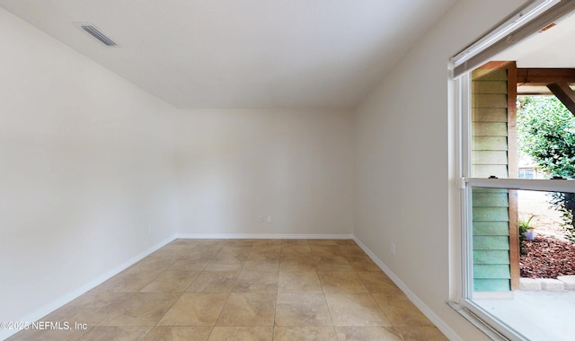 empty room with light tile patterned floors