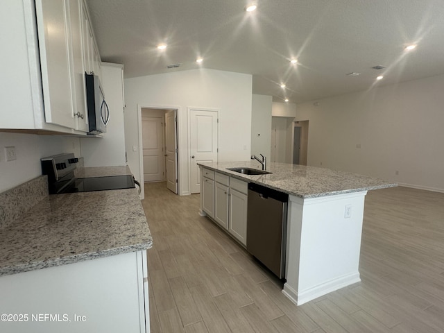 kitchen featuring a sink, light wood-style flooring, white cabinetry, and stainless steel appliances