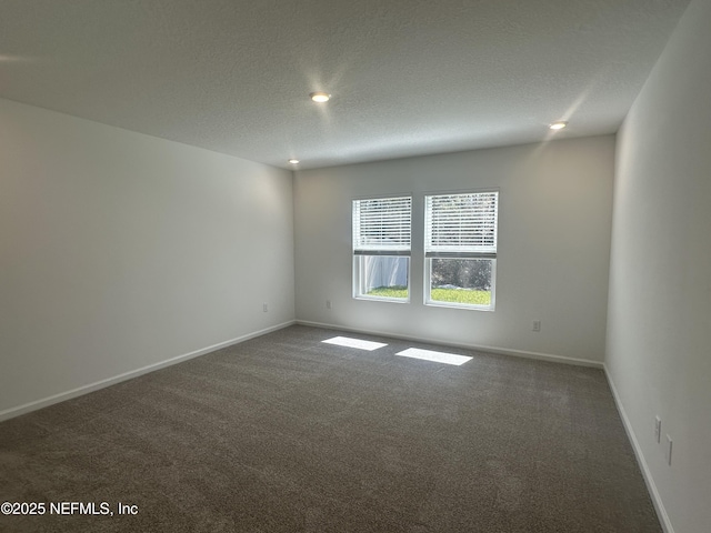 carpeted empty room with recessed lighting, baseboards, and a textured ceiling