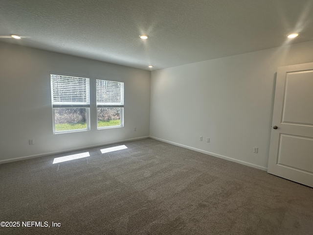 carpeted spare room featuring recessed lighting, a textured ceiling, and baseboards