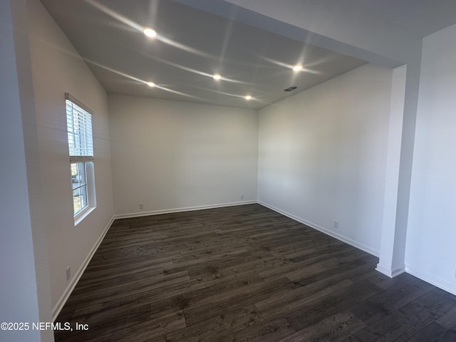 spare room featuring dark wood finished floors, recessed lighting, visible vents, and baseboards