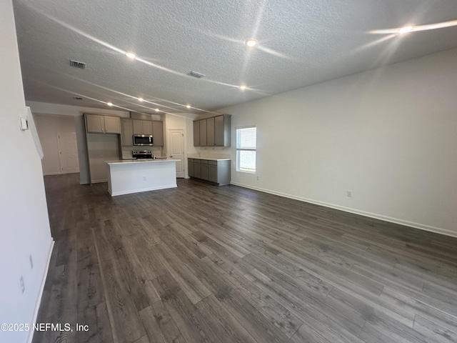 kitchen with visible vents, dark wood-style floors, open floor plan, and stainless steel appliances