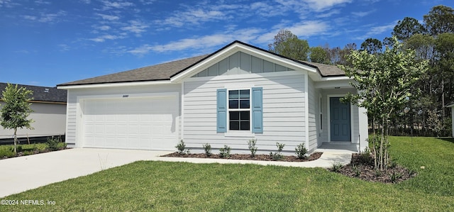 ranch-style home featuring driveway, a front lawn, board and batten siding, and an attached garage