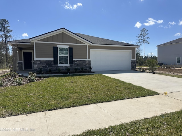 view of front of home featuring board and batten siding, concrete driveway, a front yard, stone siding, and an attached garage