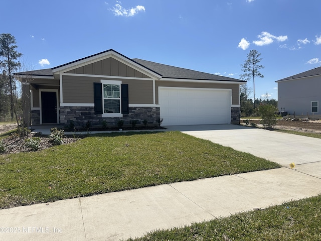 3373 Golden Eye Dr, Orange Park, FL 32065 - view of front of home featuring board and batten siding, a front lawn, a garage, stone siding, and driveway