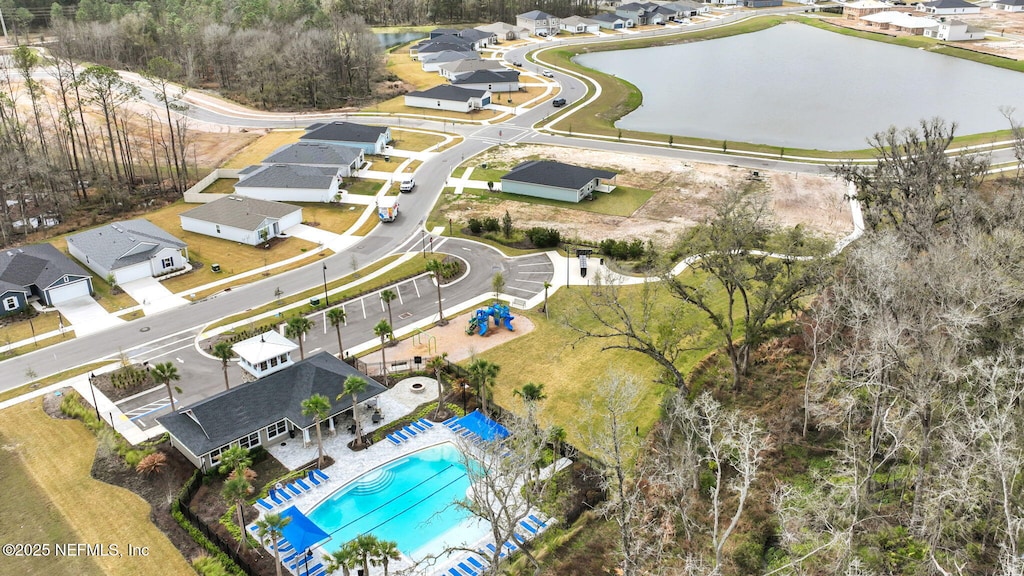 birds eye view of property with a water view and a residential view