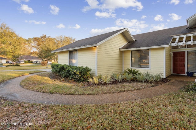 view of property exterior with a lawn