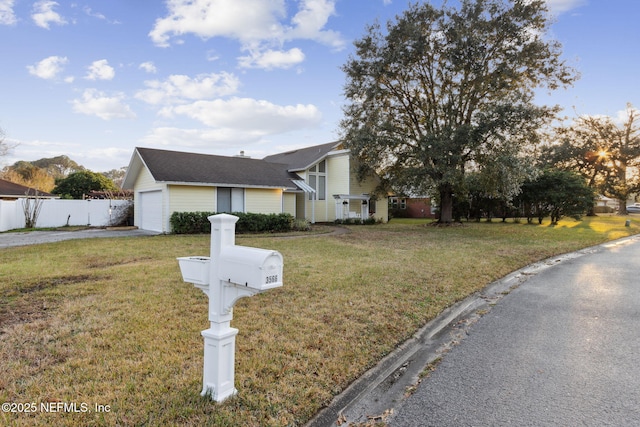 view of front facade with a garage and a front yard