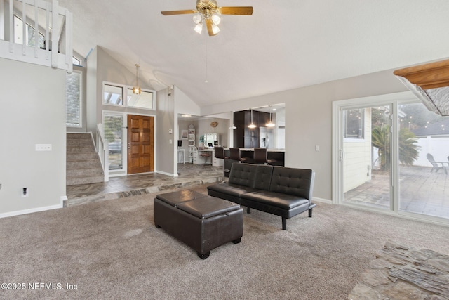 carpeted living room featuring ceiling fan and high vaulted ceiling