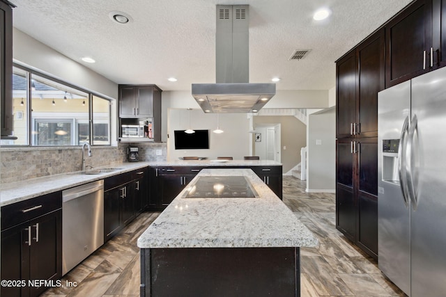 kitchen with sink, island range hood, appliances with stainless steel finishes, a kitchen island, and decorative backsplash