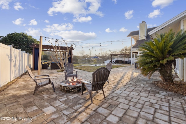 view of patio featuring a pergola and an outdoor fire pit