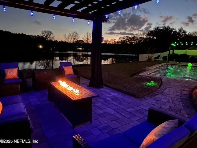 patio terrace at dusk with a fenced in pool, a water view, a pergola, and an outdoor fire pit