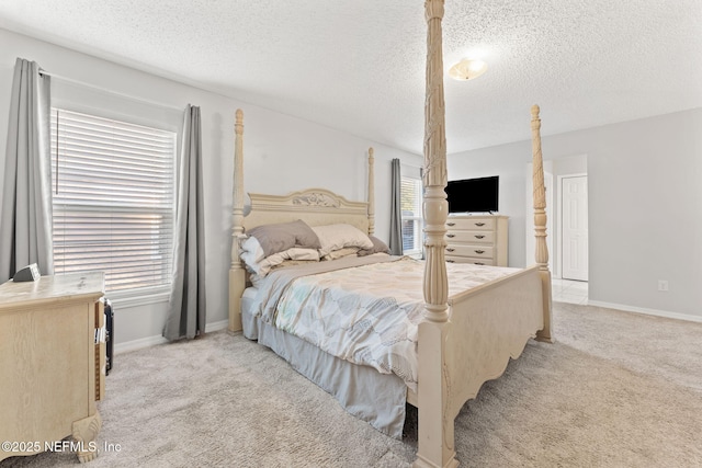 carpeted bedroom featuring a textured ceiling