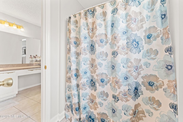 bathroom with vanity, tile patterned floors, a textured ceiling, and a shower with curtain