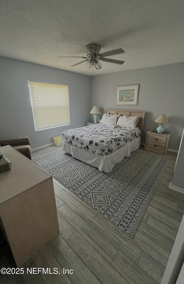 4250 A1A S Unit L16, Saint Augustine, FL 32080 - bedroom with baseboards, a textured ceiling, ceiling fan, and wood finished floors