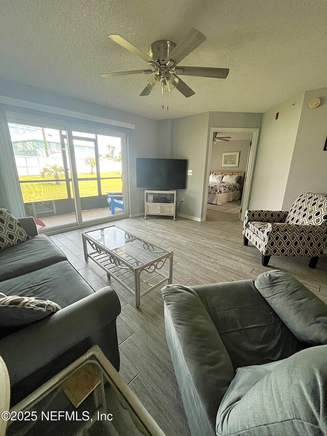 4250 A1A S Unit L16, Saint Augustine, FL 32080 - living room with a textured ceiling, ceiling fan, and wood finished floors