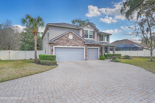 front facade featuring a garage and a front lawn