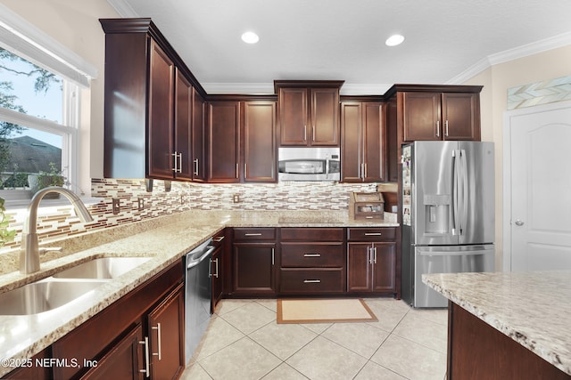 kitchen with ornamental molding, stainless steel appliances, sink, and backsplash