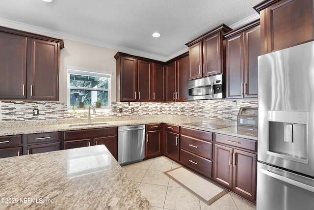 kitchen with stainless steel appliances, sink, light tile patterned floors, and light stone counters