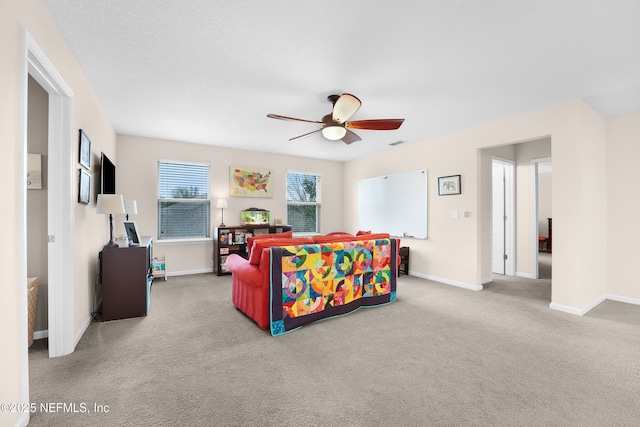 bedroom with light carpet, a textured ceiling, and ceiling fan