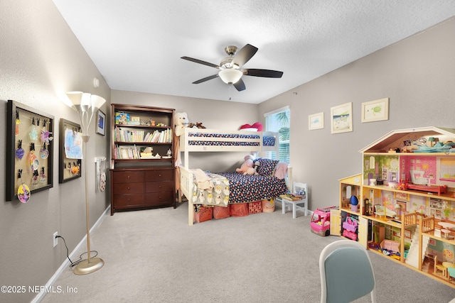 carpeted bedroom with ceiling fan and a textured ceiling