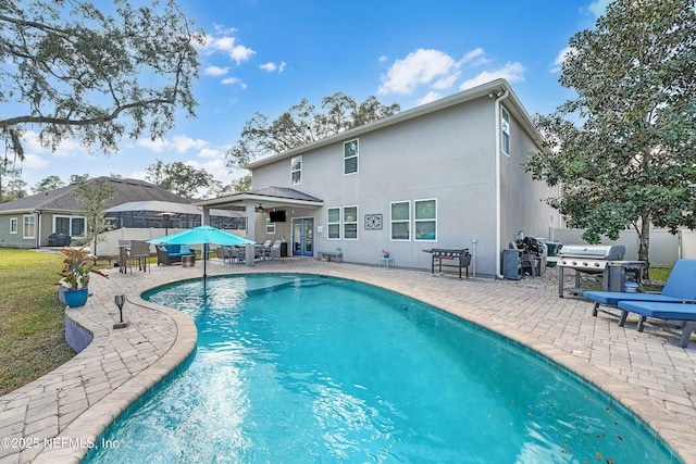 view of pool featuring a patio and a grill