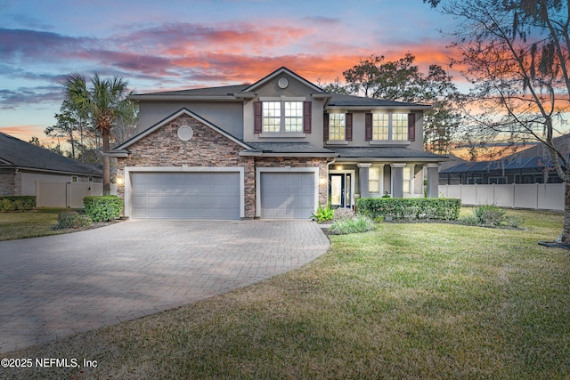 view of front of home featuring a garage and a lawn