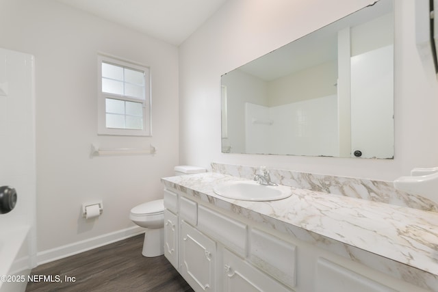 full bathroom featuring hardwood / wood-style flooring, vanity, toilet, and  shower combination