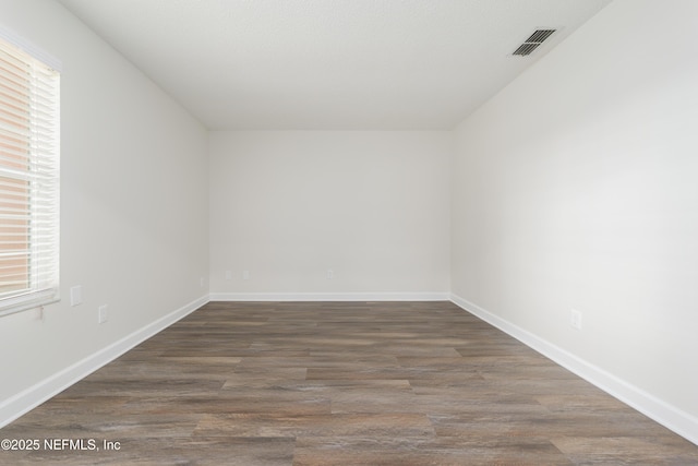 empty room featuring dark hardwood / wood-style flooring