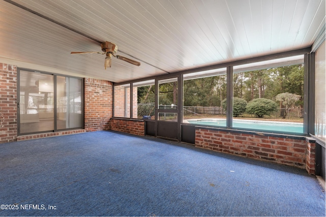 unfurnished sunroom featuring a wealth of natural light and ceiling fan