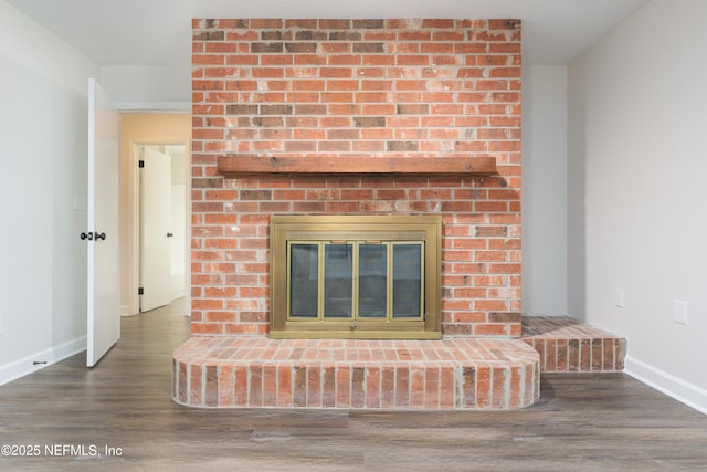 interior details with a brick fireplace and hardwood / wood-style floors