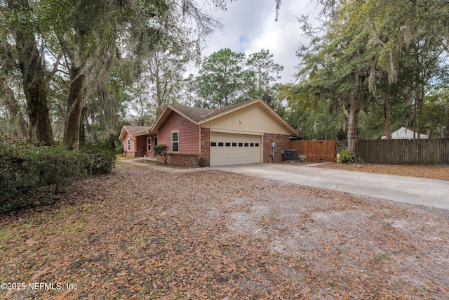 ranch-style house featuring cooling unit and a garage