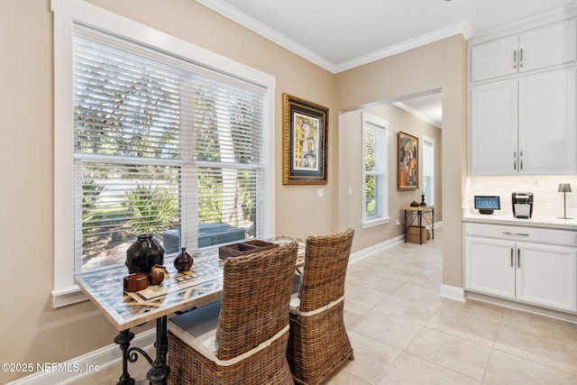 dining room with crown molding, plenty of natural light, and light tile patterned floors