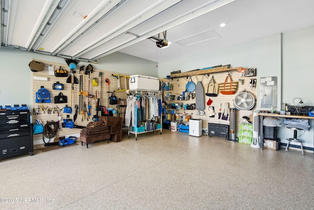 garage with a garage door opener and a workshop area