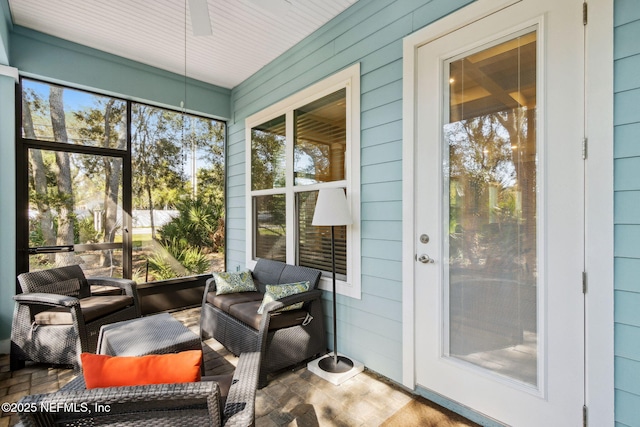 sunroom / solarium with a wealth of natural light and ceiling fan