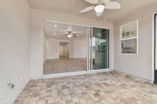 view of patio featuring ceiling fan