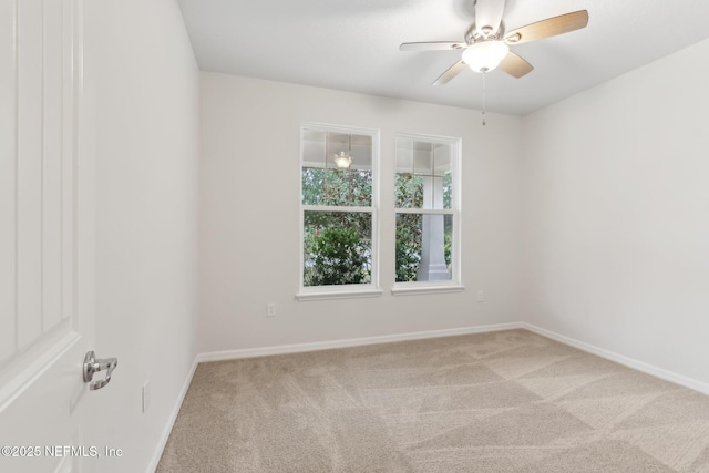 empty room with light colored carpet and ceiling fan