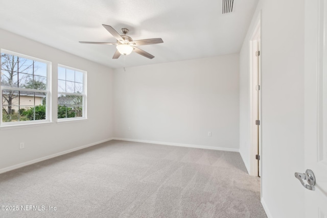 carpeted spare room featuring ceiling fan