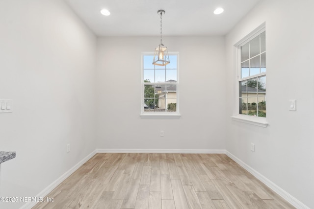 unfurnished room featuring a healthy amount of sunlight and light hardwood / wood-style flooring