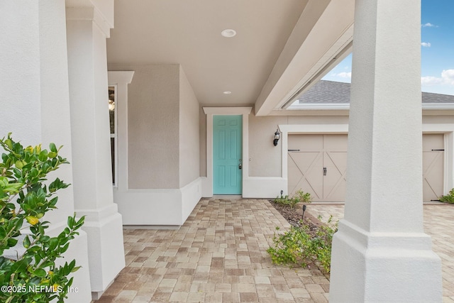 view of exterior entry with a garage