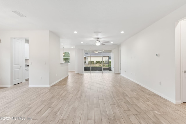 unfurnished living room featuring light hardwood / wood-style flooring and ceiling fan