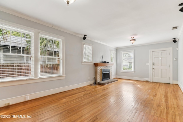 unfurnished living room with crown molding, a fireplace, and light hardwood / wood-style flooring