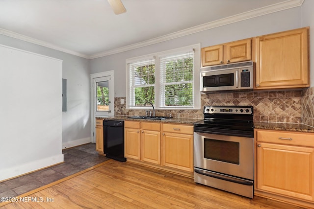 kitchen featuring appliances with stainless steel finishes, backsplash, and dark stone counters