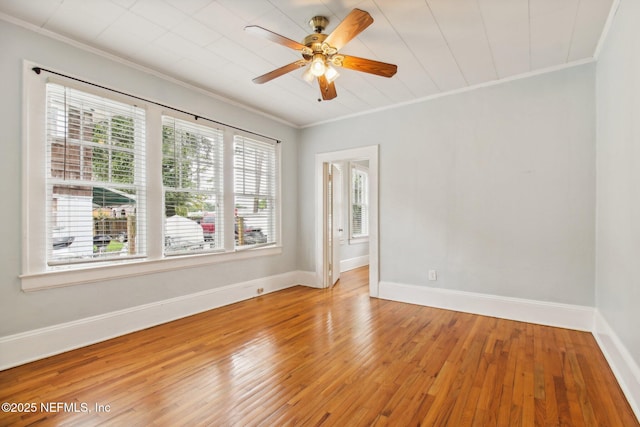 empty room with ornamental molding and wood-type flooring