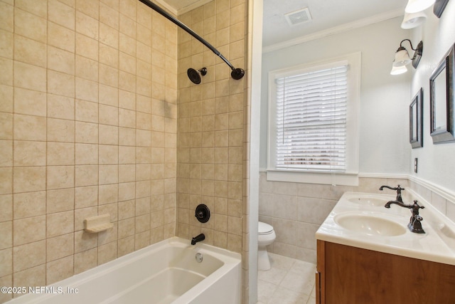 full bathroom with tiled shower / bath, tile walls, ornamental molding, vanity, and toilet