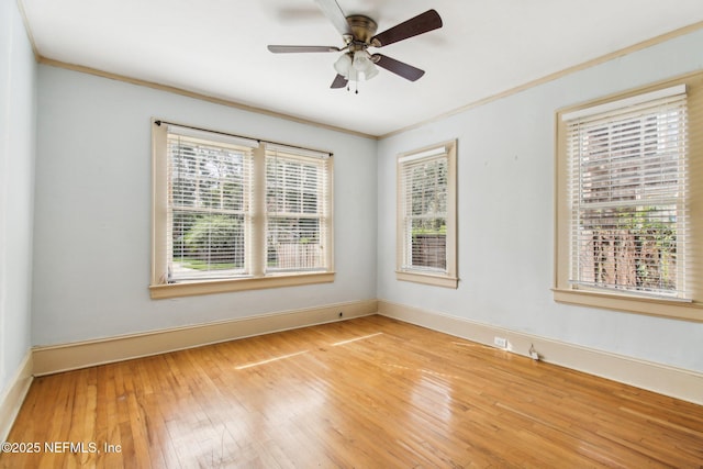 spare room with hardwood / wood-style flooring, crown molding, and ceiling fan