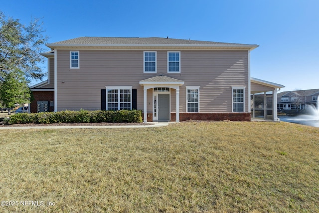 view of front of home with a front lawn and a sunroom