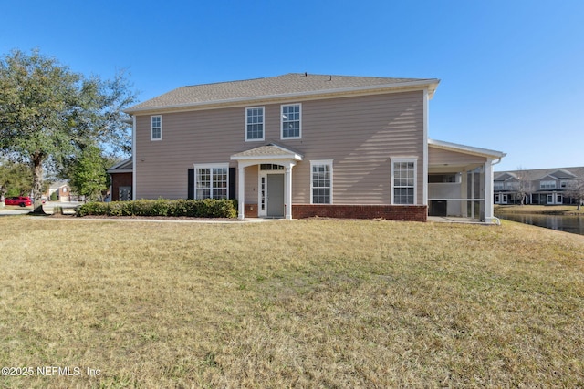 view of front of home with a sunroom and a front yard