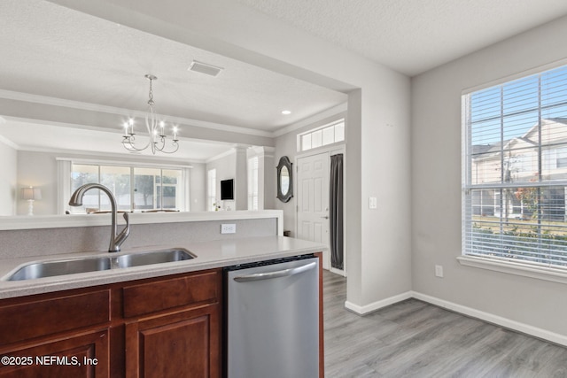 kitchen with sink, a textured ceiling, light wood-type flooring, stainless steel dishwasher, and ornate columns