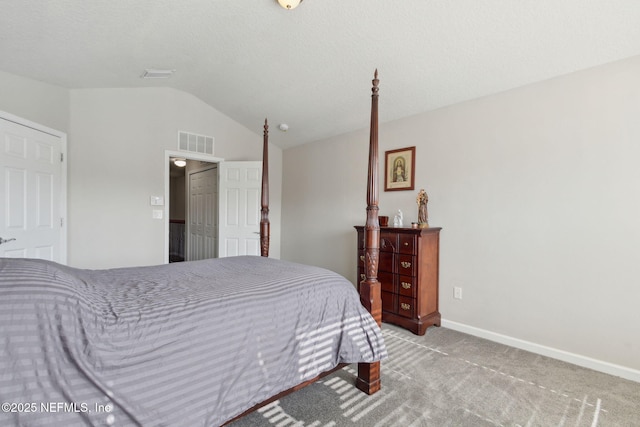 carpeted bedroom with lofted ceiling